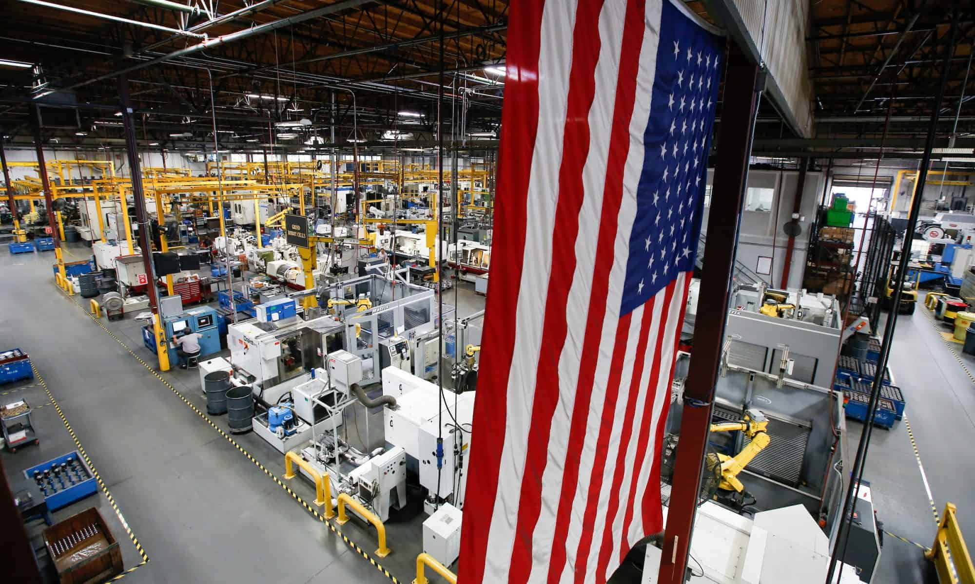 American flag hanging above a manufacturing shop floor